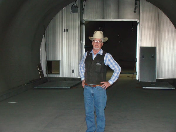 Lee Hudson standing proudly in the newly built Hudson Ranch wine cave.